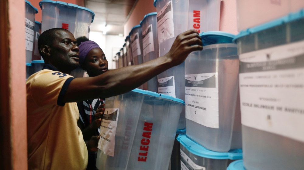 Officials check ballot boxes before distributing them to polling stations for Sunday's presidential election in Yaounde [Zohra Bensemra/Reuters] 
