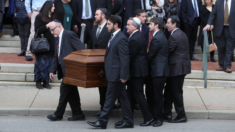 A coffin is carried from Rodef Shalom Temple after funeral services for brothers Cecil and David Rosenthal, victims of the Tree of Life Synagogue shooting [Cathal McNaughton/Reuters] 