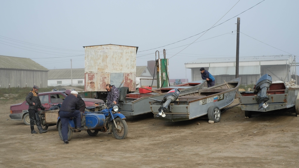 Fishermen gather with their boats in Kraynovka, a small village on the shore of the Caspian Sea [Nikolay Korzhov/Al Jazeera]