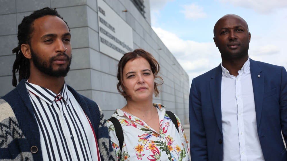 Rui Moniz, left, stands outside the court with lawyers Lucia Gomes, centre, and Jose Semedo Fernandes, right [Ana Naomi de Sousa/Al Jazeera]