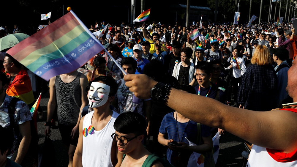 People waved rainbow banners and placards printed with slogans saying