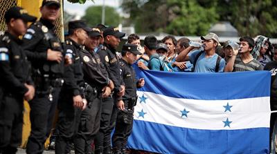 The caravan trying to reach the US faced delays at Tecun Uman, Guatemala, where police attempted to stop them [Ueslei Marcelino/Reuters]