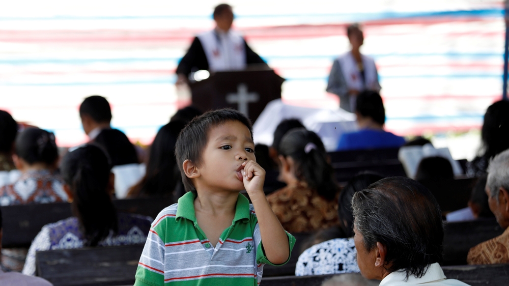 Children in the Indonesian city of Palu began returning to school on Monday [Darren Whiteside/Reuters]