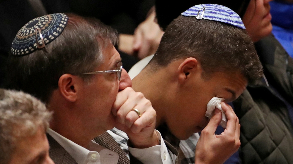 Mourners at a memorial service at the Sailors and Soldiers Memorial Hall of the University of Pittsburgh [Cathal McNaughton/Reuters]