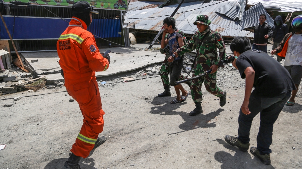 The Indonesian army arrested a man for stealing motorcycle spare parts and confiscated the sword he was armed with [Ted Regencia/Al Jazeera]