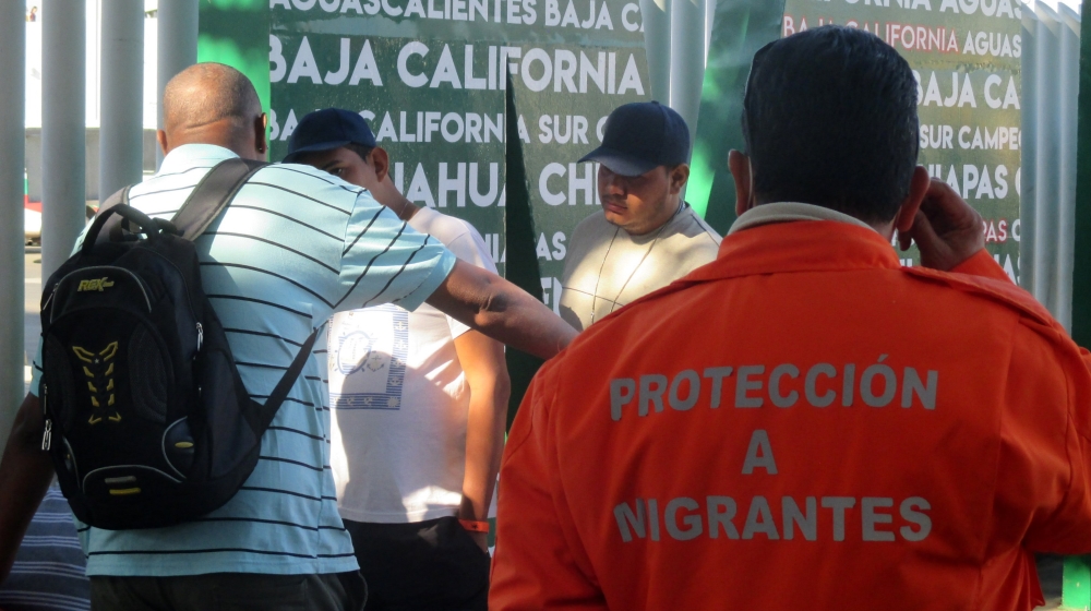 Asylum seekers must sign up on waiting list and wait for number to be called before attempting to enter the US [Sandra Cuffe/Al Jazeera] 