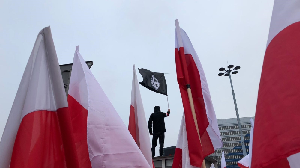  One man raised a flag bearing the Celtic Cross, which is used as a hate symbol by neo-Nazis [Agnieszka Pikulicka-Wilczewska/Al Jazeera] One man raised a flag bearing the Celtic Cross, which is used as a hate symbol by neo-Nazis [Agnieszka Pikulicka-Wilczewska/Al Jazeera]