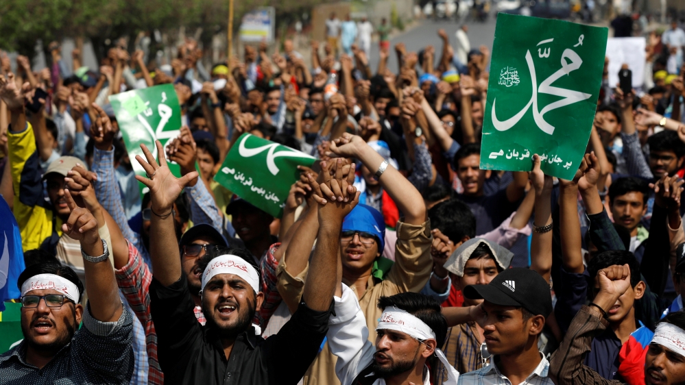 Supporters of Jamiat Talba Islam hold placards as they chant slogans during a protest in Karachi