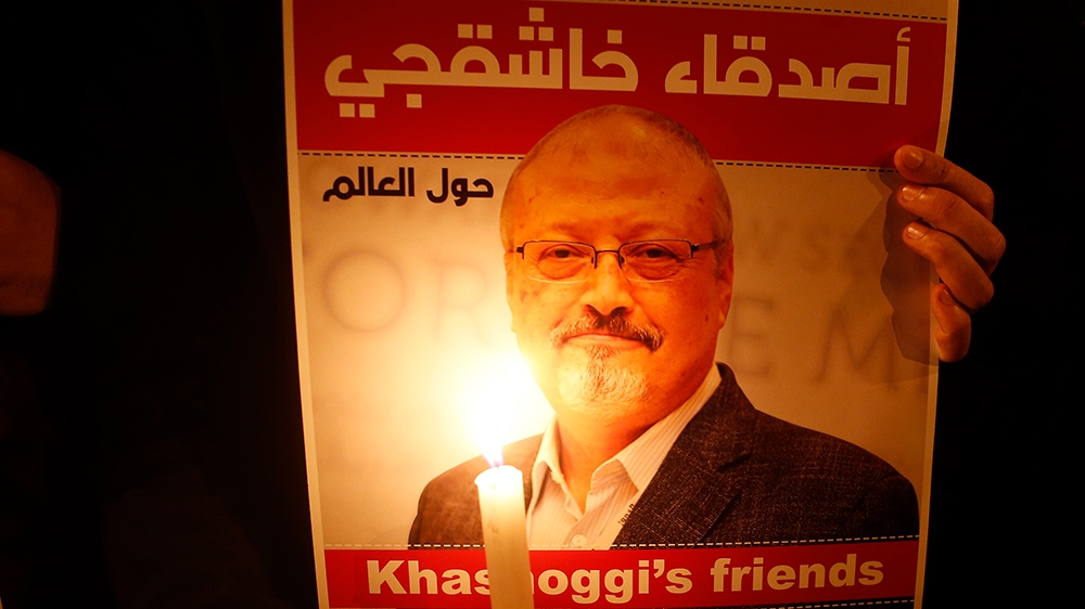 Activists, protesting the killing of Saudi journalist Jamal Khashoggi, hold a candlelight vigil outside Saudi Arabia''s consulate in Istanbul, Thursday, Oct. 25, 2018. The poster reads in Arabic:'' Khas