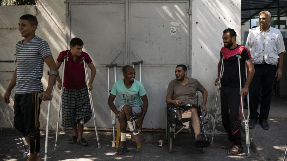 Patients with leg injuries they attained during demonstrations, gather outside a clinic run by MSF in Gaza City in September 2018 [Associated Press]