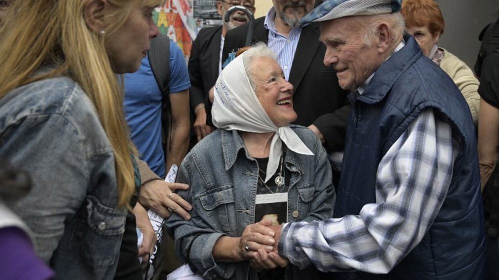 Several former Ford workers who became political prisoners at the camp, including Carlos Gareis (R), were present for the verdict [Juan Mabrmata/AFP]