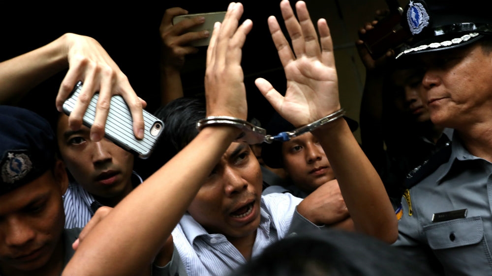 
Kyaw Soe Oo leaves court in Yangon after being sentenced to seven years in prison for violating Myanmar's Official Secrets Act [Ann Wang/Reuters]
