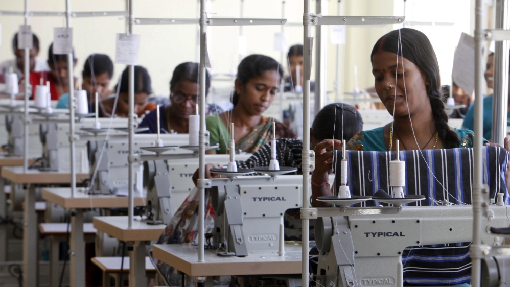 Indian workers sew at a garment factory on the outskirts of Hyderabad, India, Friday, Oct. 12, 2012.