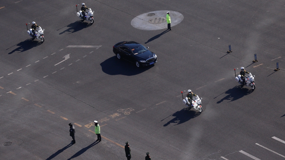 A vehicle that is part of a motorcade that is believed to be carrying Kim makes its way through central Beijing [Thomas Peter/Reuters]