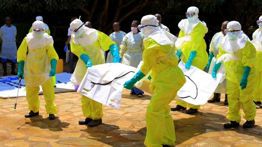Congolese officials and the World Health Organization officials wear protective suits as they participate in a training against the Ebola virus near the town of Beni
