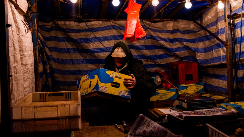 Lambert has been selling vegetables at Ridley Road Market for 40 years; he will be retiring soon but says he will miss his customers and fellow traders [Jose Sarmento Matos/Al Jazeera]