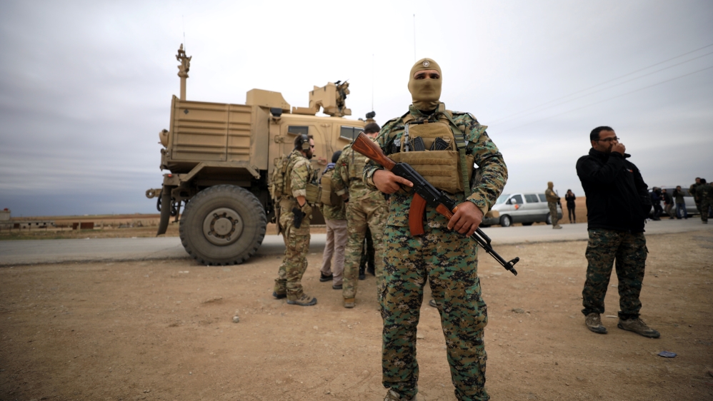 Syrian Democratic Forces and U.S. troops are seen during a patrol near Turkish border in Hasakah