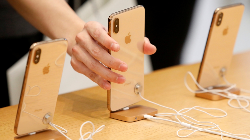 People look at iPhones at the World Trade Center Apple Store during a Black Friday sales event in Manhattan, New York City