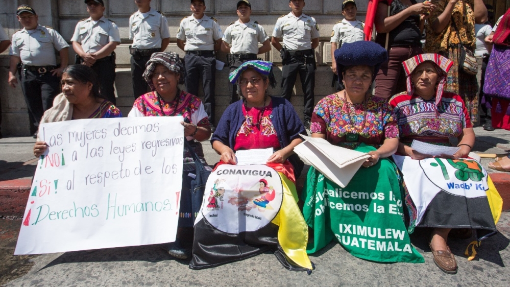 CONAVIGUA coordinator Rosalina Tuyuc (second from left) and other group members protest on February 13 outside Congress against the amnesty bill [Jeff Abbott/Al Jazeera] 