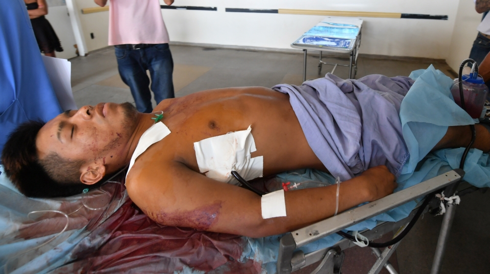 An indigenous man injured during clashes with Venezuelan soldiers arrives at the hospital in Boa Vista [Nelson Almeida/AFP]