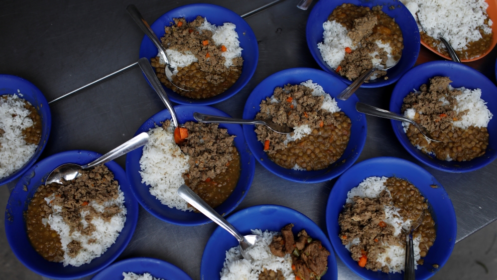 Plates of food are seen at a community kitchen set-up by USAID and World Food Programme [Marco Bello/Reuters] 