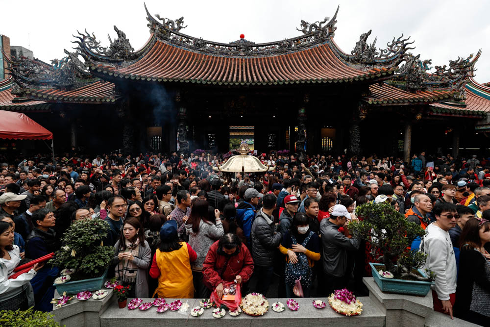 People pray, offer flowers and food inside the Lungshan Temple during the Chinese New Year celebration in Taipei, Taiwan, 05 February 2019. The Chinese New Year, or Year of the Pig, begins on 05 Febru
