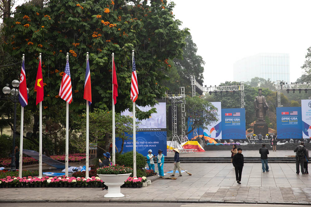 The square opposite the Hoan Kiem Lake in Hanoi is hosting an exhibition but also providing locals and tourists a photo spot with the Us, North Korean and Vietnamese flags. [Faras Ghani/Al Jazeera]