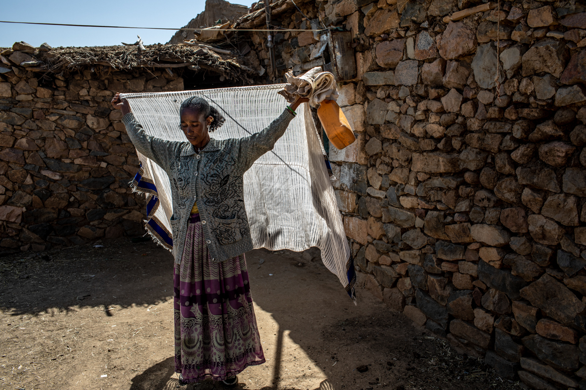 Birhan T/medhin, a 40-year-old mother of four, sets off for a distribution point to collect her family''s monthly rations in Hawzen district, Misraqawi Zone, Tigray Region, Ethiopia, on February 6, 201
