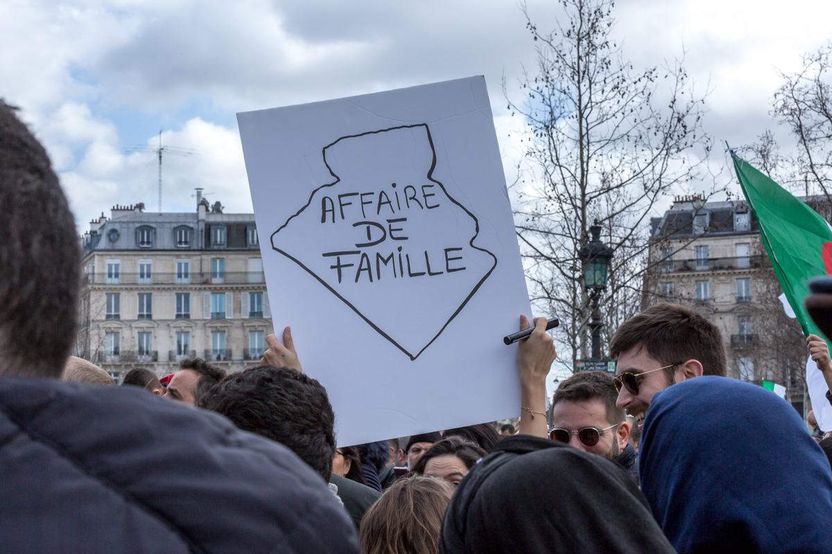 An Algerian protester holds a sign with a map of Algeria denouncing the country being run by a family business during a demonstration against Algerian President Abdelaziz Bouteflika seeking a fifth te
