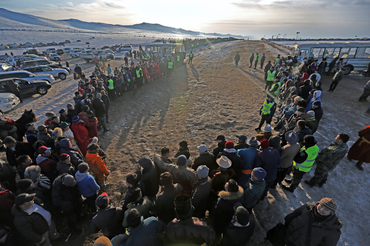 A crowd gathers at the finish line, eager to see who wins the race. Mongolian horse races are among the longest in the world, covering distances of 18km to 26km. [Odbayar Urkhensuren/Al Jazeera]
