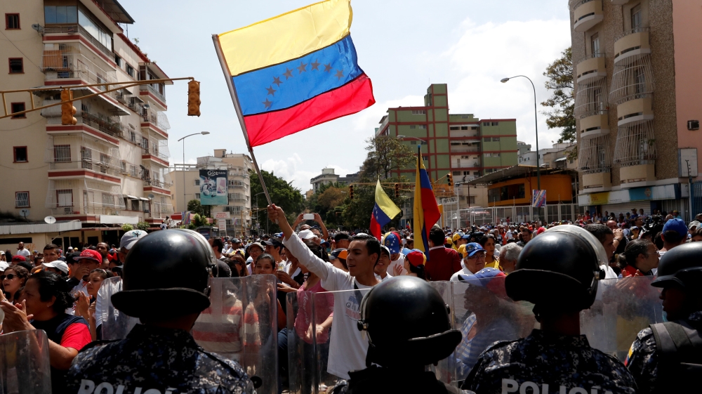 Opposition supporters take part in anti-Maduro rally [Carlos Garcia Rawlins/Reuters]