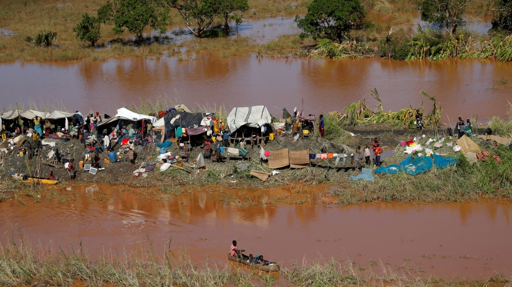 Stranded locals look on during floods after Cyclone Idai, in Buzi district, outside Beira