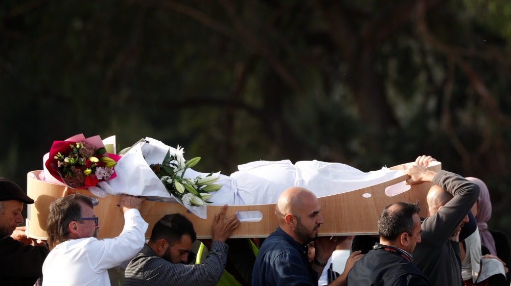 People carry the body of a victim during a burial ceremony for victims of the mosque attacks, at the Memorial Park Cemetery in Christchurch, New Zealand March 22, 2019