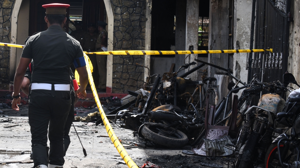 Sri Lankan security personnel walk past debris outside Zion Church following an explosion in Batticaloa [Lakruwan Wanniarachchi/ AFP]