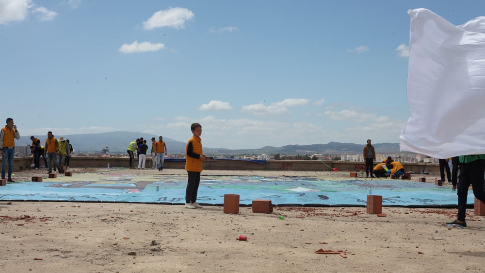 Ouled El Djebasse putting the finishing touches on the weekly tifo [Maher Mezahi/Al Jazeera]