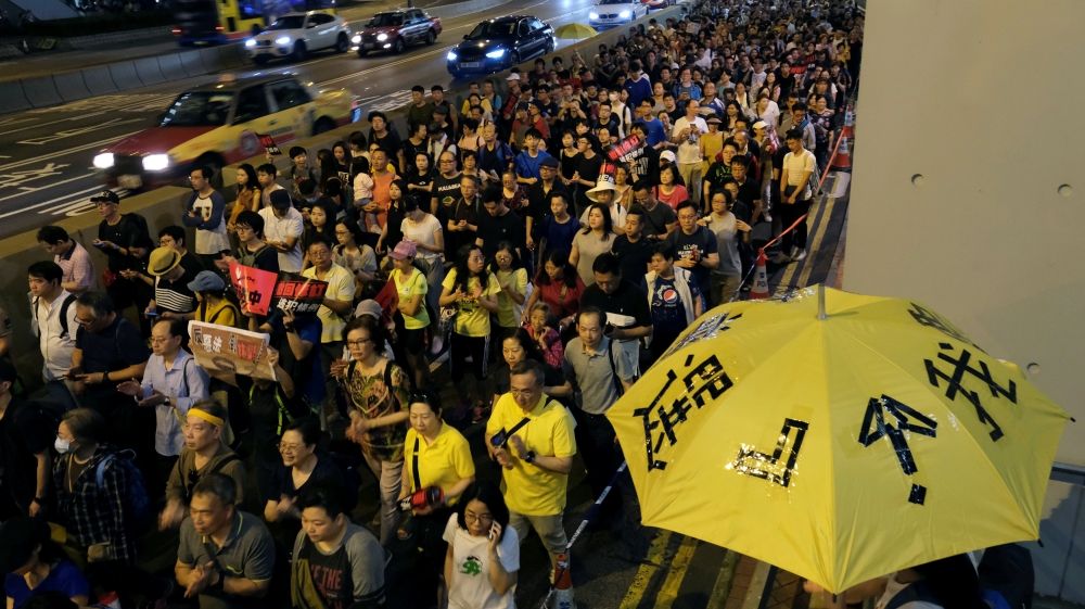 Demonstrators hold yellow umbrellas, the symbol of the Occupy Central movement during a protest to demand authorities scrap a proposed extradition bill with China, in Hong Kong