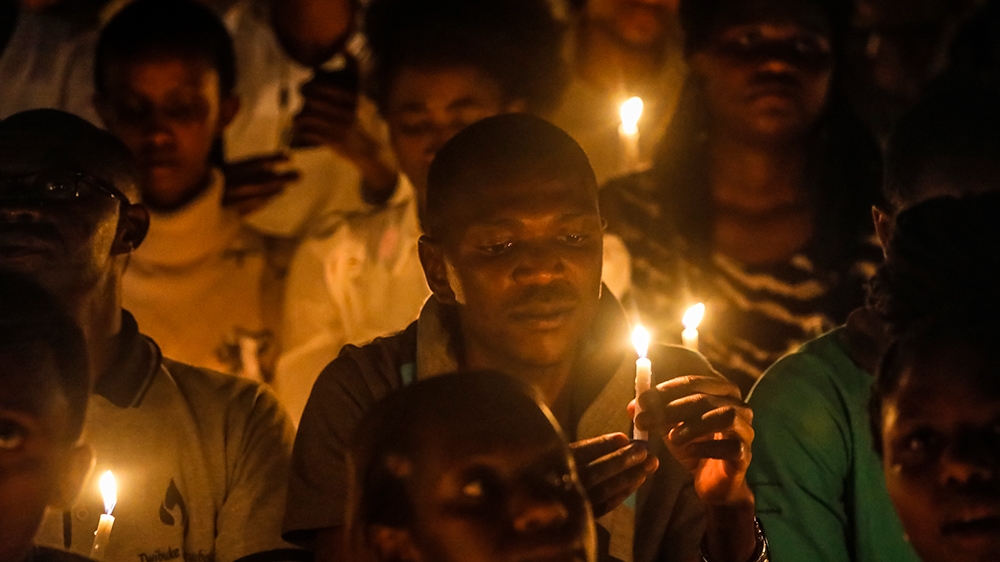 People hold candles during a candle light vigil for those who were killed in the 1994 genocide, during a commemoration event at Amahoro stadium in the capital Kigali, Rwanda, 07 April 2019. Tens of th