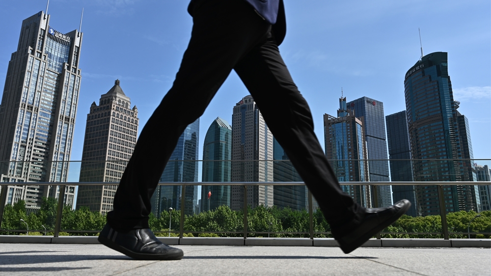 CHINA-US-TRADE-DIPLOMACY A man walks on a bridge in the financial district in Shanghai on May 7, 2019. Hope for an imminent resolution of the China-US trade dispute dimmed after US President Trump