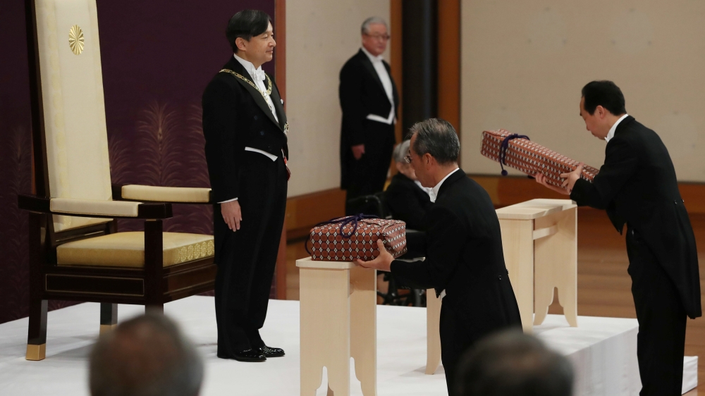 Japan''s Emperor Naruhito stands as Imperial Household Agency officials carry two of the so-called Three Sacred Treasures of Japan, during a ritual called Kenji-to-Shokei-no-gi, a ceremony for inheriti