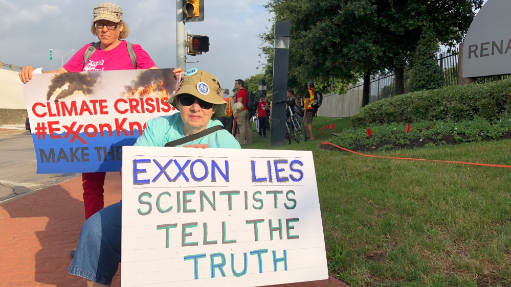 Blanca Gonzales and Susan Cooper protest ExxonMobil''s climate change policies as people arrive at the 2019 annual shareholders meeting in Dallas