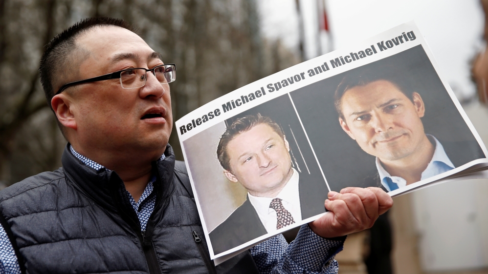 Louis Huang holds a placard ccalling for China to release Canadian detainees Michael Spavor and Michael Kovrig outside a court hearing for Huawei Technologies Chief Financial Officer Meng Wanzhou at t