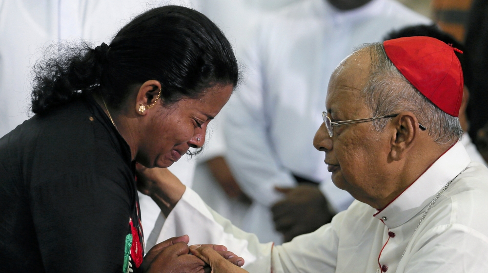 A family member of one of the victims of the Easter bombings breaks down as she meets Archbishop of Colombo, Cardinal Malcolm Ranjith [Dinuka Liyanawatte/Reuters]