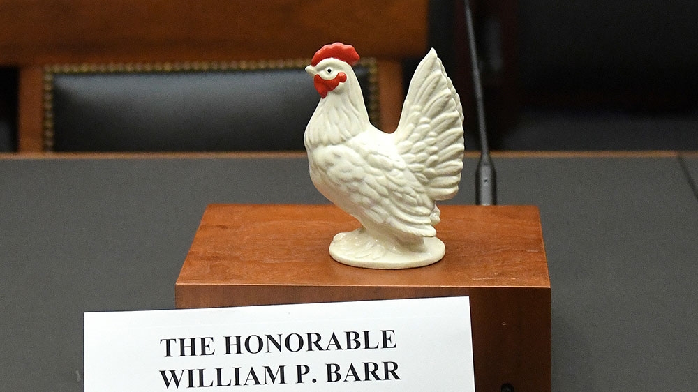 A statue of a chicken sits above the nameplate and near the empty seat of US Attorney General William Barr, who was scheduled to appear at a House Judiciary Committee hearing on the Justice Department's investigation of Russian interference [Clodagh Kilcoyne/Reuters] 