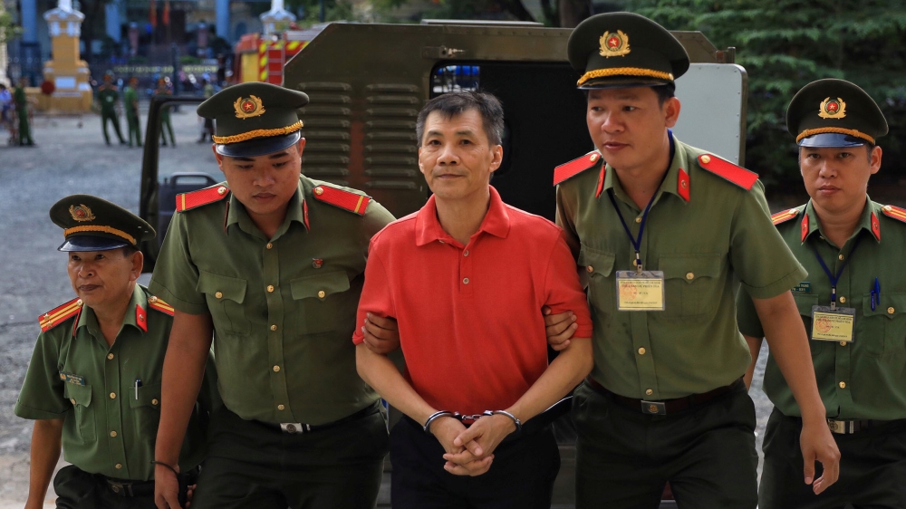U.S. citizen Michael Nguyen is escorted by policemen before his trial at a court in Ho Chi Minh city, Vietnam June 24, 2019. REUTERS/Stringer NO RESALES. NO ARCHIVES. VIETNAM OUT