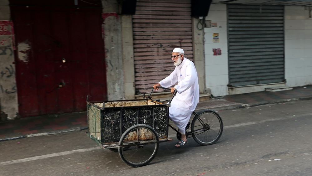A man rides his bicycle cart past closed shops as Palestinians call for a general strike to protest against Bahrain''s economic workshop for U.S. Middle East peace plan, in the southern Gaza Strip