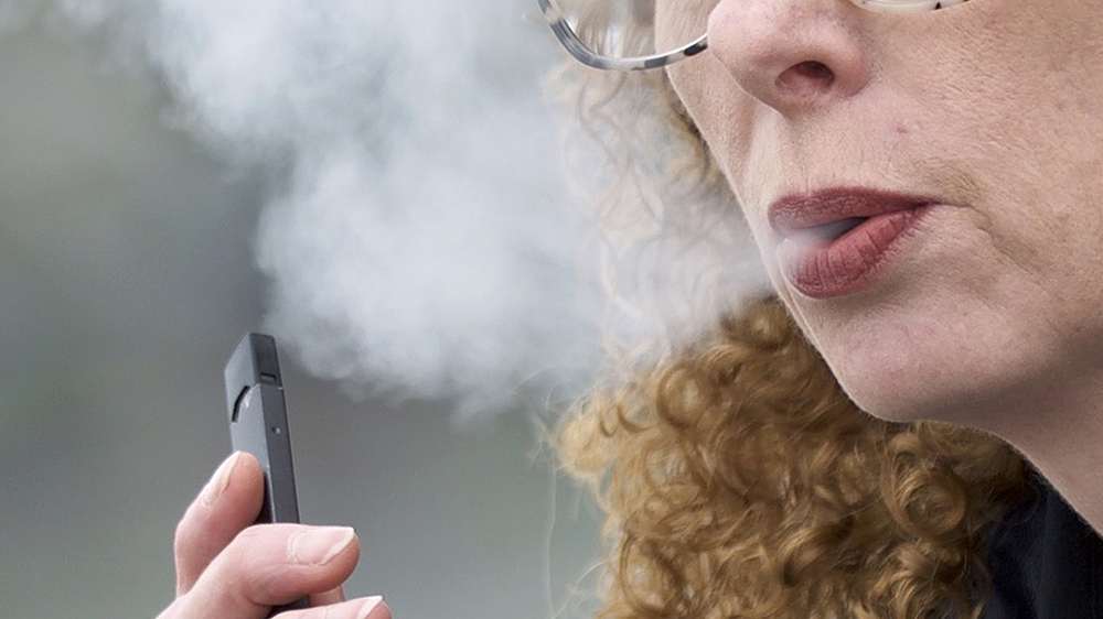 Woman puffing an e-cigarette in Washington state