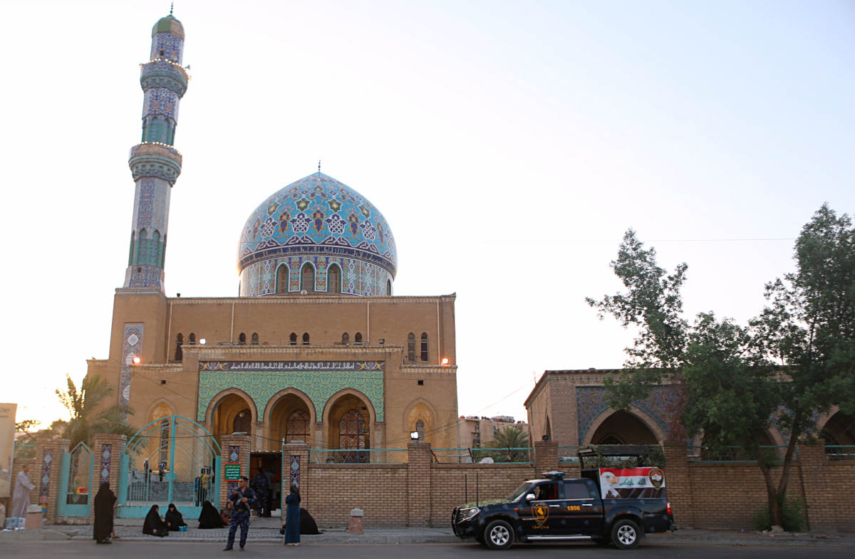 Security forces stand guard outside the 17th of Ramadan mosque as Muslims gather for prayers on the first day of Eid al-Fitr in Baghdad, Iraq, Tuesday, June 4, 2019. Eid al-Fitr marks the end of the M