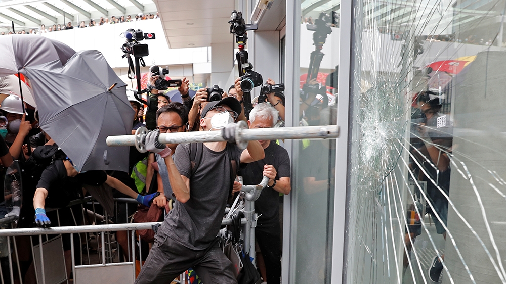 Protesters try to break into the Legislative Council building where riot police are seen, during the anniversary of Hong Kong's handover to China in Hong Kong, China July 1, 2019. REUTERS/Tyrone Siu 