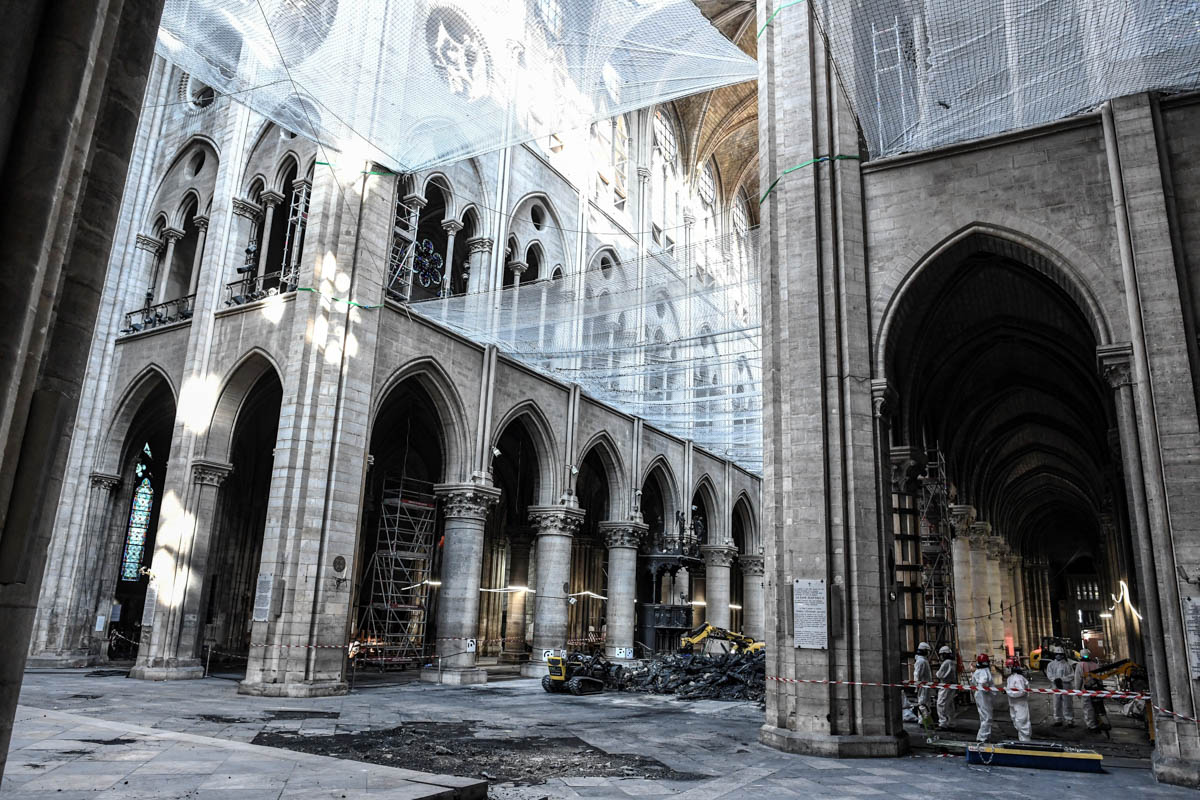 A picture shows damage on the nave and rubble during preliminary work in the Notre-Dame de Paris Cathedral three months after a major fire on July 17, 2019 in Paris. French MPs on July 16 approved a l