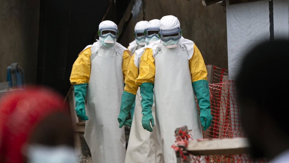 In this Tuesday, July 16, 2019 photo, health workers dressed in protective gear begin their shift at an Ebola treatment center in Beni, Congo DRC. The World Health Organization has declared the Ebola